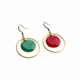 Ramona Mulvey Jewellery Mayo 2026 asymmetrical drop earrings with red and green discs in polished gold-tone hoops.