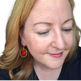 Ramona Mulvey Jewellery Mayo 2026 drop earrings featuring a glossy red disc inside a polished gold-tone hoop